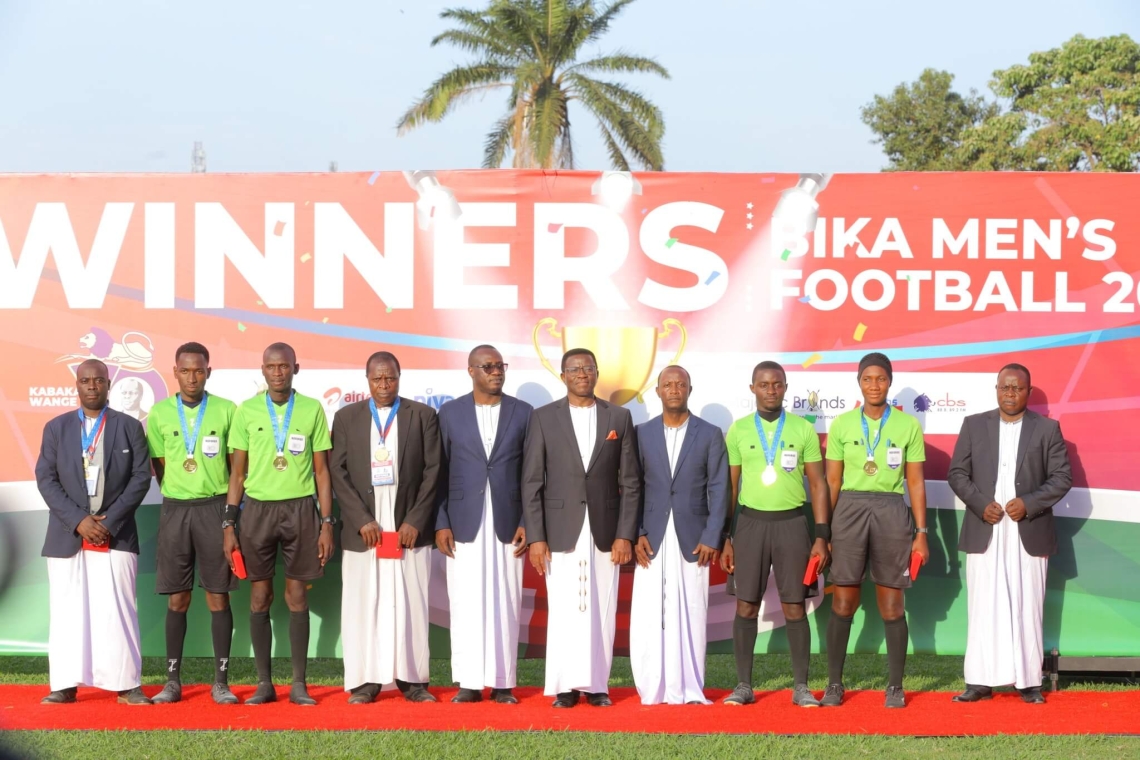Katikkiro Charles Peter Mayiga poses with the victorious Ngabi Nsamba team after their win in the 2025 Clan Games